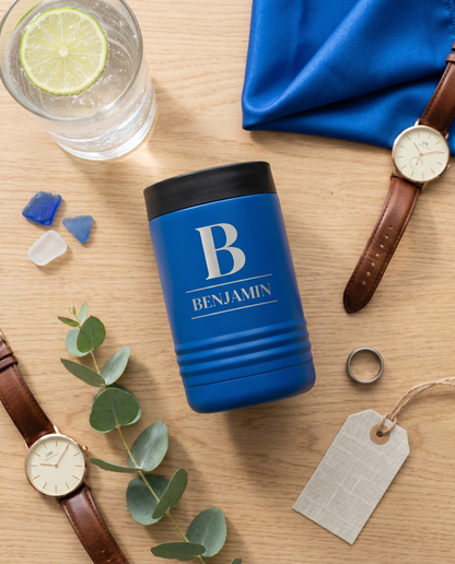 Personalized royal blue stainless steel insulated can cooler flat lay with gin and tonic and leather watch