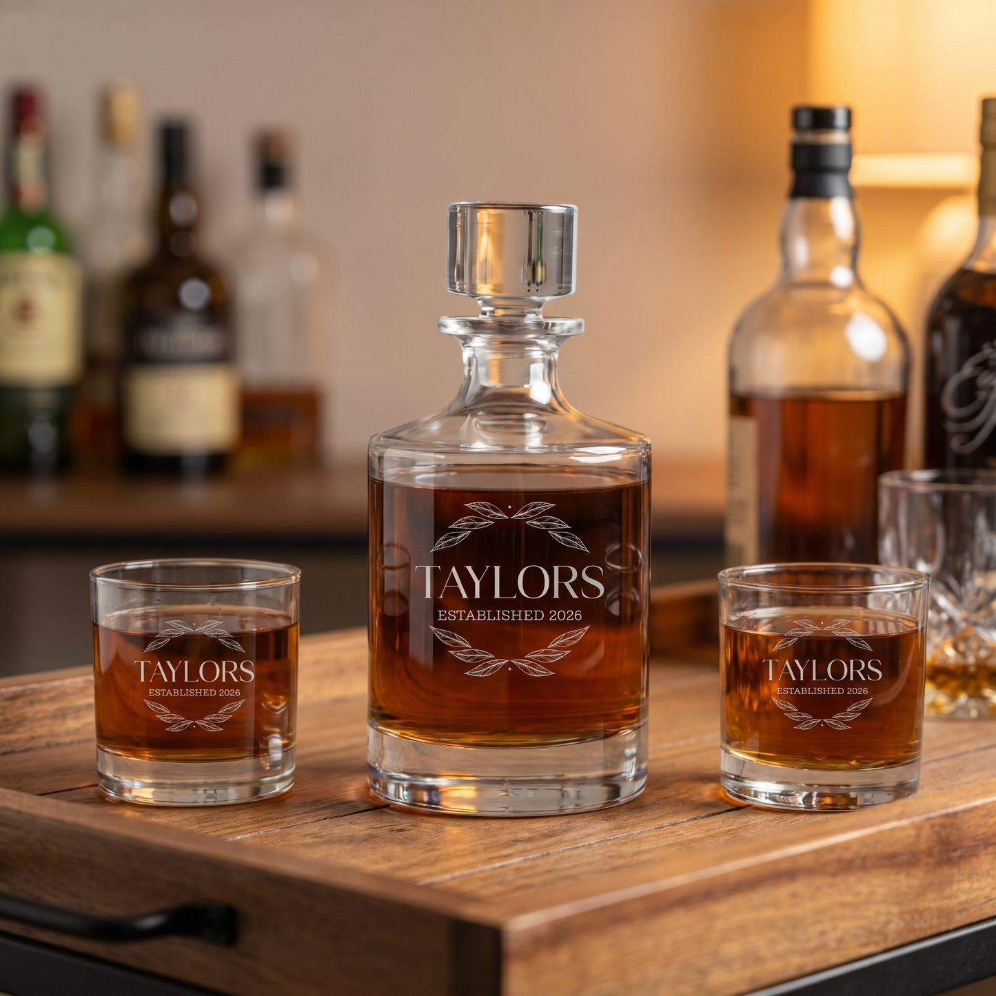 Personalized barrel whiskey decanter set engraved with family name and established date on a home bar