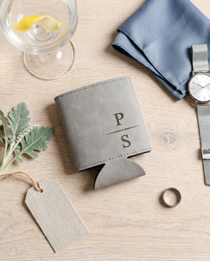 Personalized grey vegan leather groomsmen can cooler flat lay with cocktail glass and silver watch
