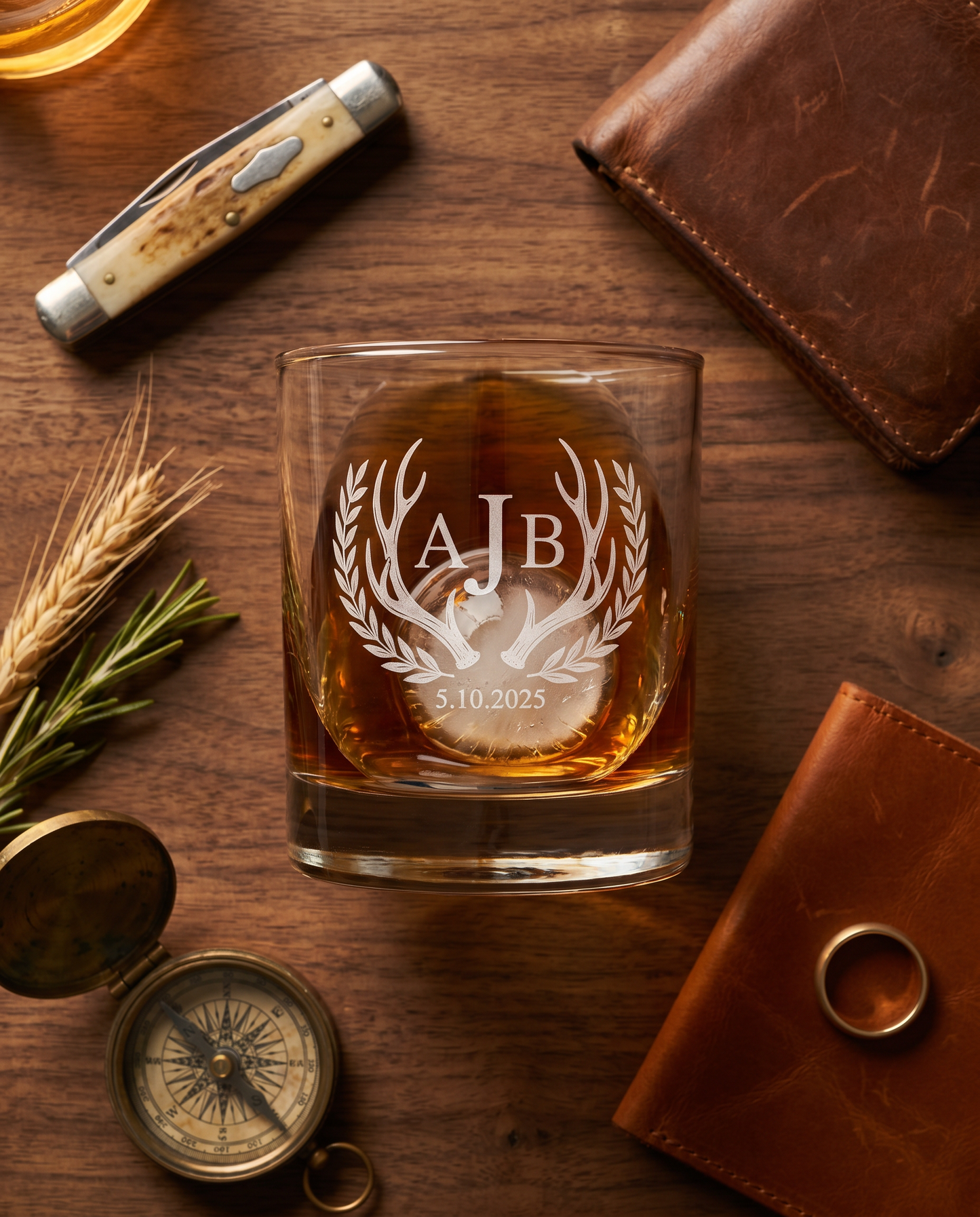 Personalized lowball whiskey glass with antler and laurel monogram engraving — hunting cabin styling