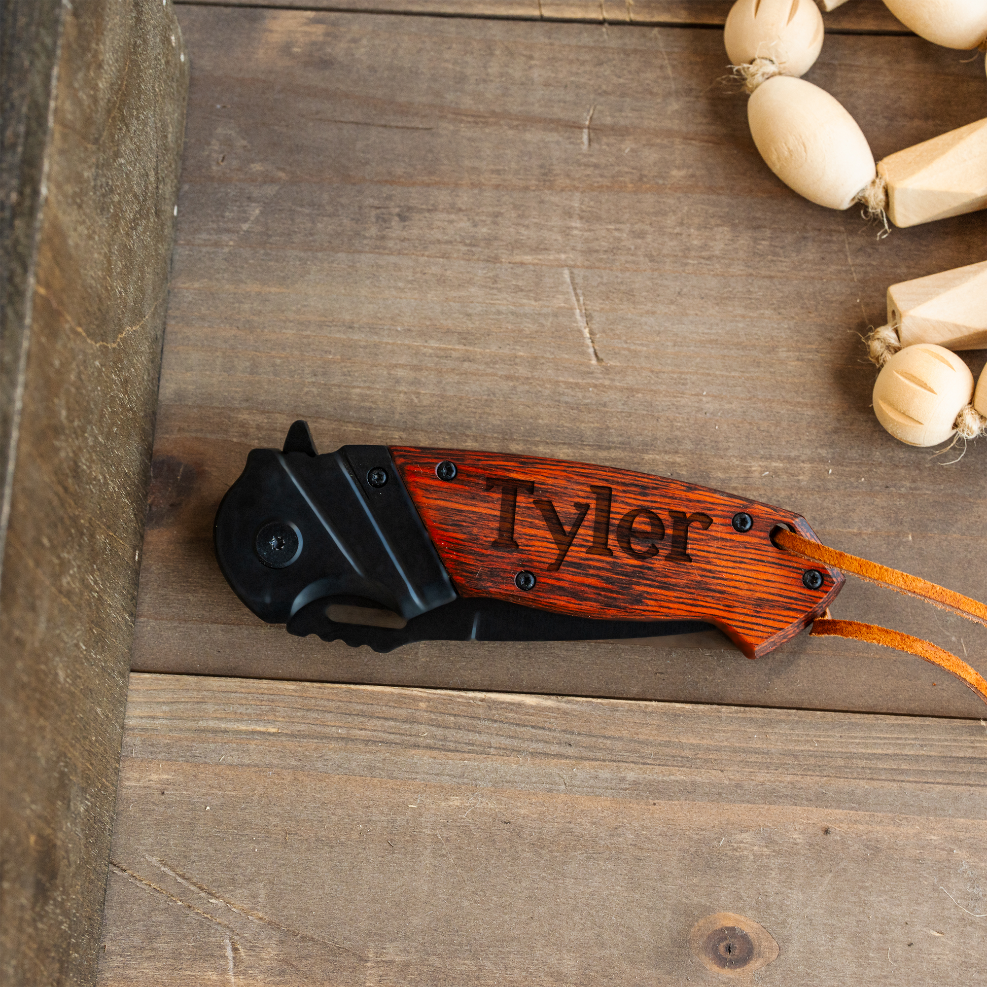 Custom engraved red handle knife in wooden presentation box view 2