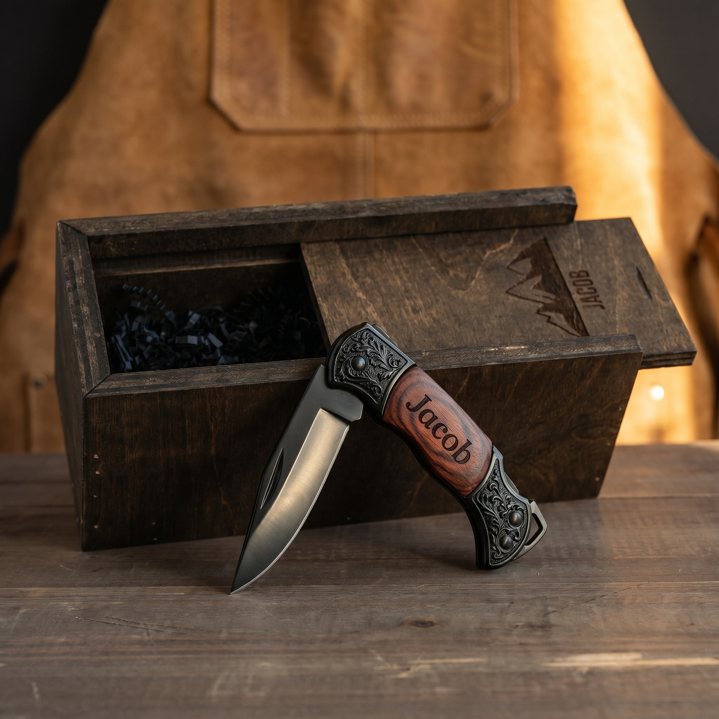 Personalized engraved pocket knife with rosewood handle and wooden gift box, leather apron backdrop