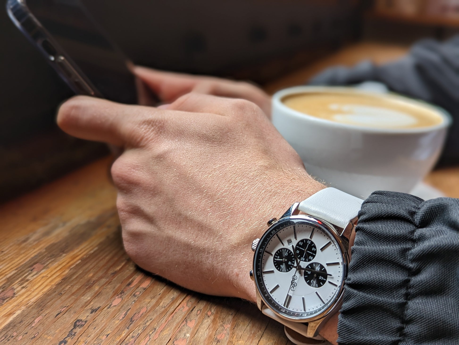 White and black chronograph close-up showing dial and case details