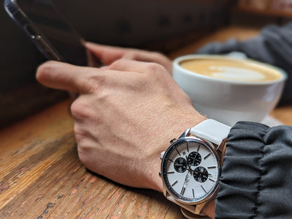 White and black chronograph close-up showing dial and case details